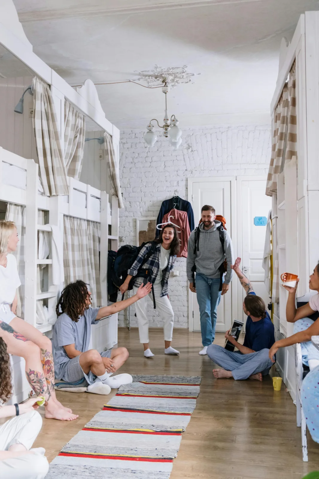 Travelers chatting in a hostel common area